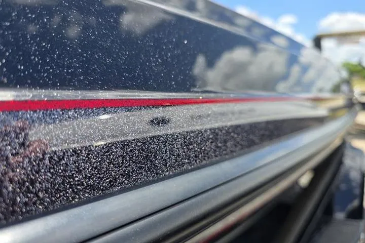 Slide: The Image of Close-up of 2024 Ranger Z518 Cup-Equipped boat with metallic finish and red stripe. - 6