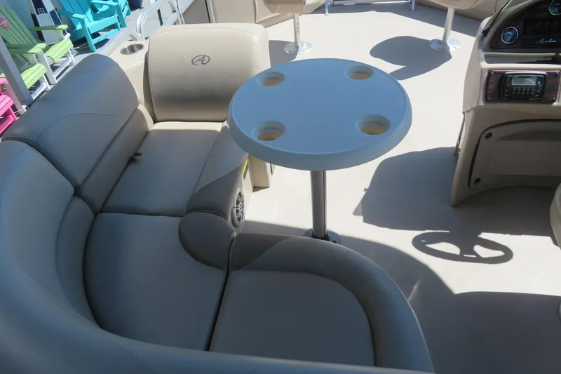 Slide: The Image of 2015 Avalon GS 2185 RF boat interior with beige seating and round table. - 15