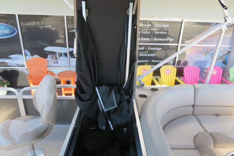 Slide: The Image of 2015 Avalon GS 2185 RF boat interior with seating and colorful chairs outside. - 17
