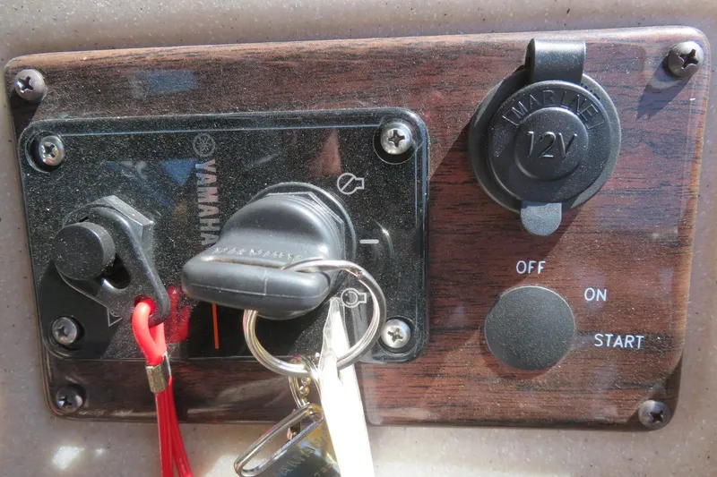 Slide: The Image of Control panel of a 2015 Avalon GS 2185 RF with ignition keys and 12V outlet. - 31