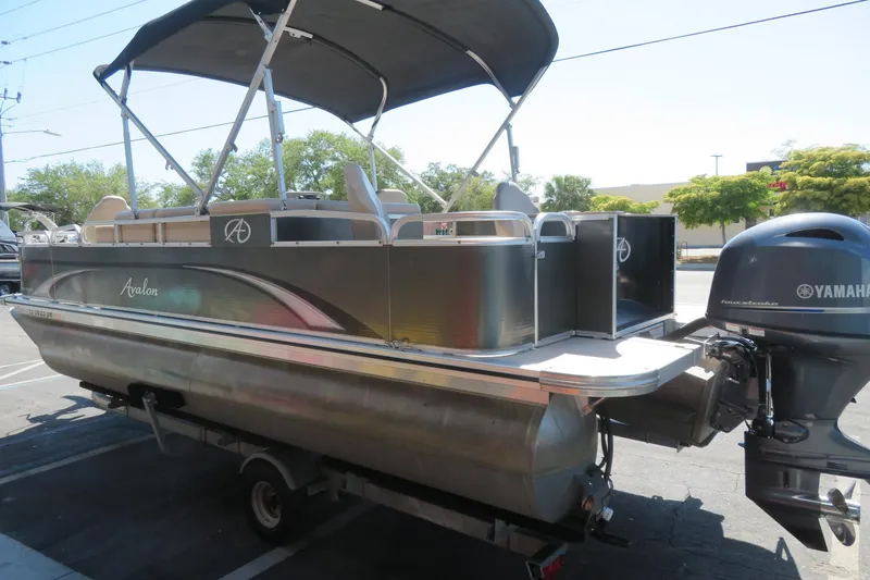 Slide: The Image of 2015 Avalon GS 2185 RF pontoon boat with Yamaha outboard motor, parked on trailer. - 4