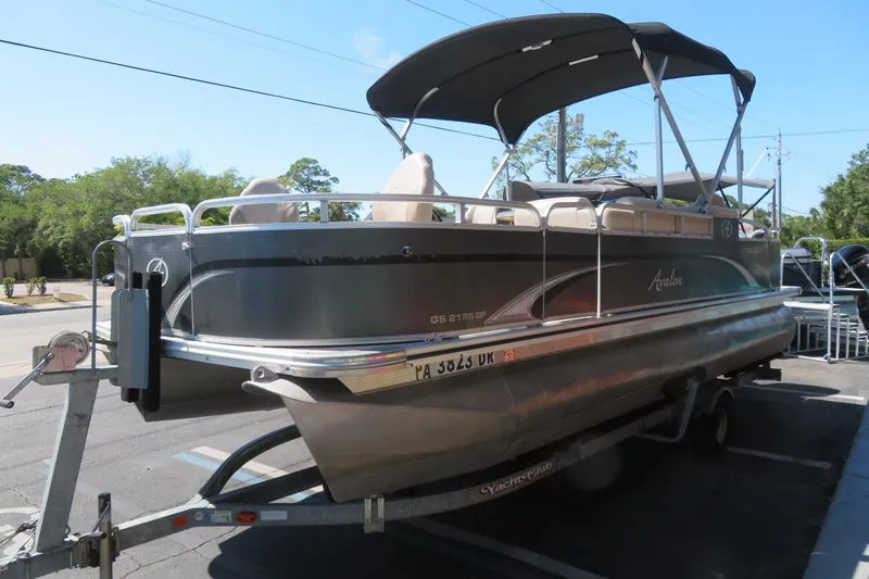 Slide: The Image of 2015 Avalon GS 2185 RF pontoon boat on trailer, parked outdoors. - 5