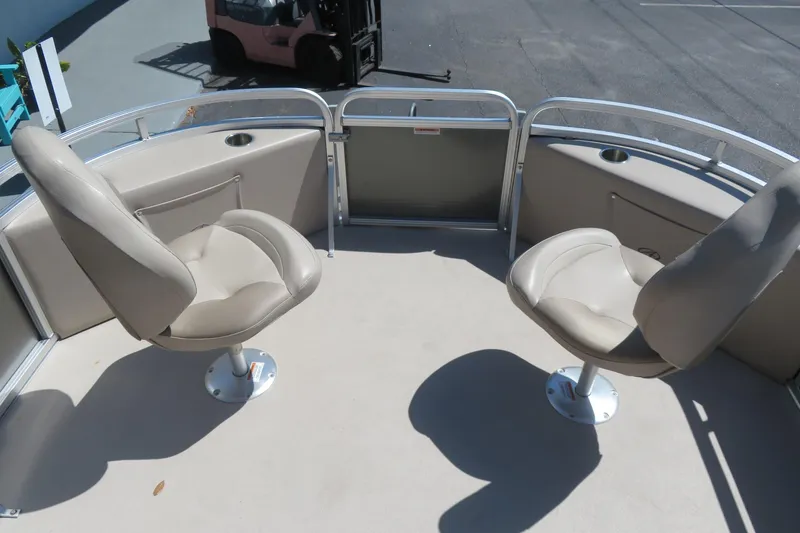 Slide: The Image of 2015 Avalon GS 2185 RF boat interior with two swivel seats and cup holders. - 8