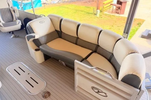 Slide: The Image of 2019 Veranda VP25RC pontoon boat interior with plush seating and modern design. - 2