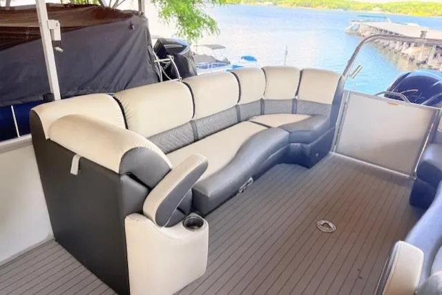 Slide: The Image of 2019 Veranda VP25RC pontoon boat with spacious seating, docked by a scenic lake. - 3