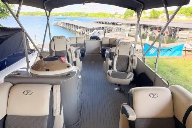 Slide: The Image of 2019 Veranda VP25RC pontoon boat with spacious seating, docked by a scenic lake. - 4