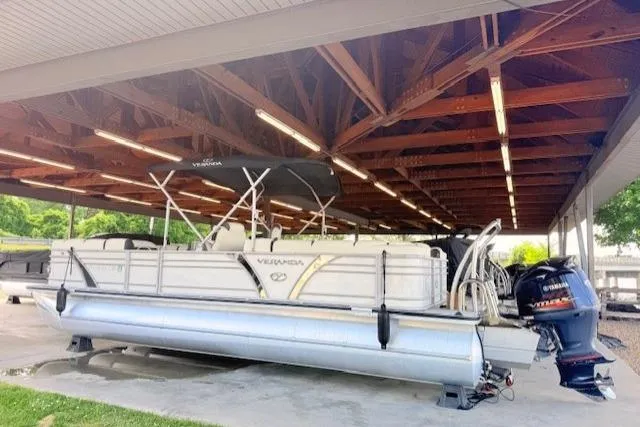 Slide: The Image of 2019 Veranda VP25RC pontoon boat under a wooden shelter with Yamaha outboard motor. - 5