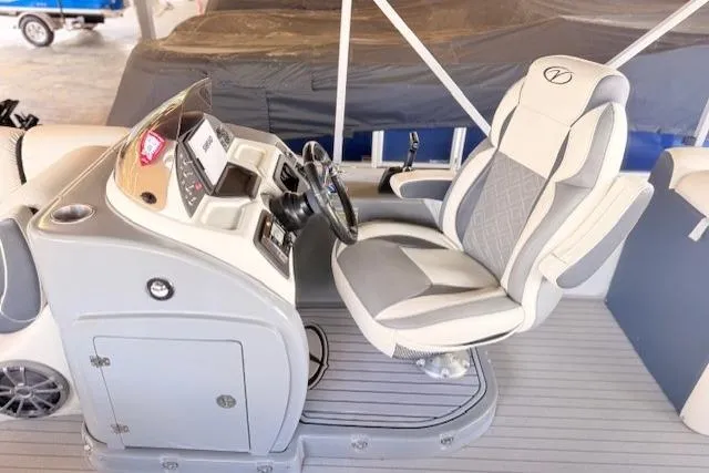 Slide: The Image of Captain's chair and helm of 2019 Veranda VP25RC pontoon boat, featuring modern controls. - 6