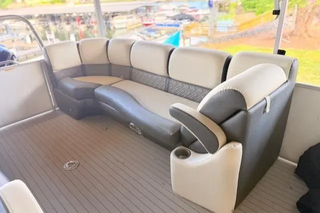 Slide: The Image of 2019 Veranda VP25RC boat interior with plush seating and cup holders. - 8