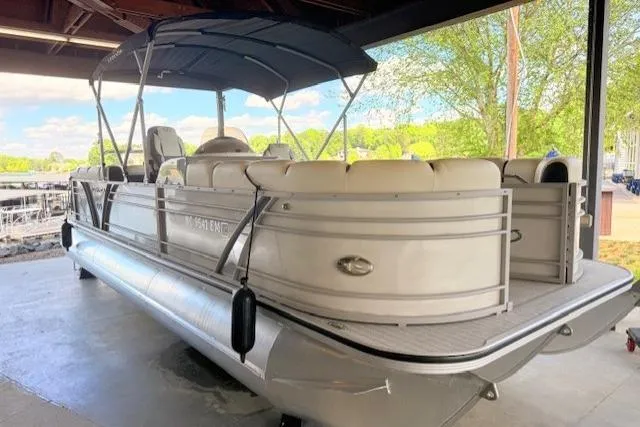 Slide: The Image of 2019 Veranda VP25RC pontoon boat under a canopy, featuring spacious seating and sleek design. - 9
