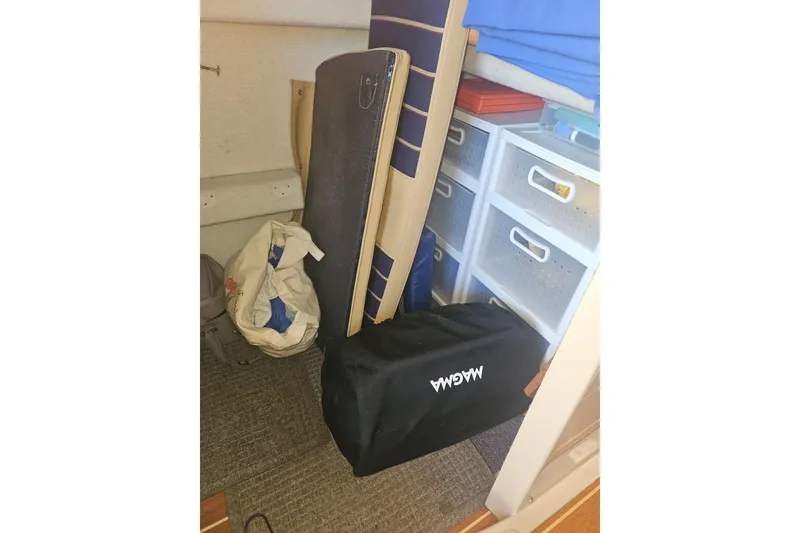 Slide: The Image of Storage area inside a 2014 Ranger Tugs R-27 boat with bags and drawers. - 23