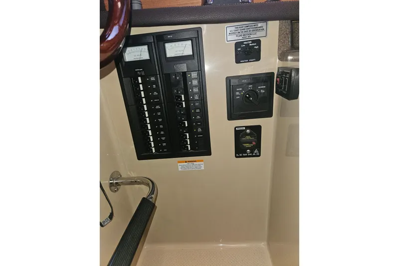 Slide: The Image of Control panel of a 2014 Ranger Tugs R-27 boat with various switches and gauges. - 26