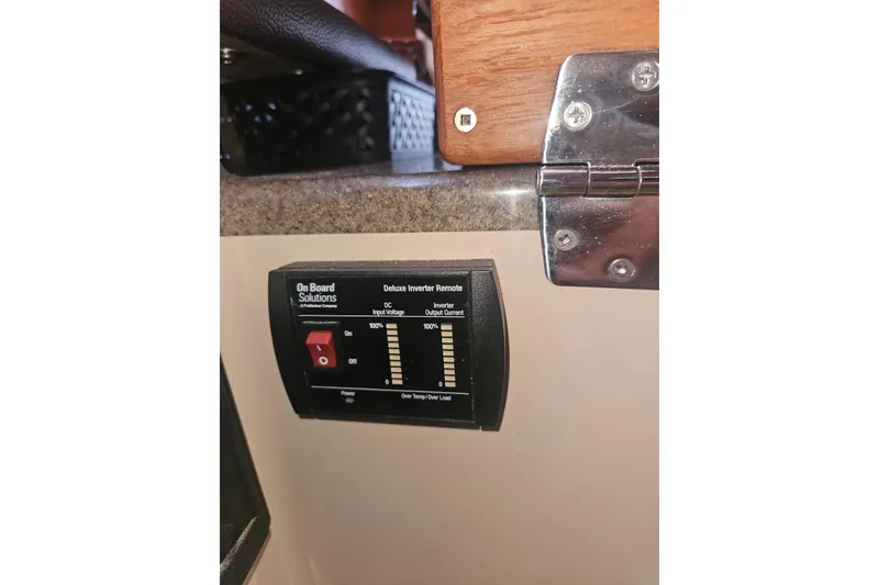 Slide: The Image of Onboard Solutions inverter control panel in 2014 Ranger Tugs R-27 boat interior. - 27