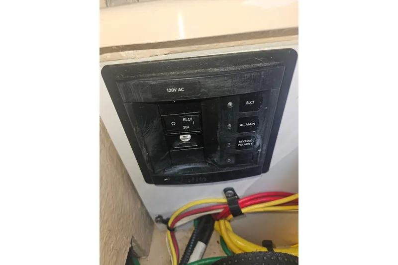 Slide: The Image of Electrical panel on a 2014 Ranger Tugs R-27 boat, featuring 120V AC switches. - 41
