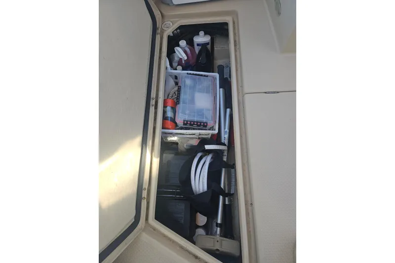 Slide: The Image of Storage compartment of 2014 Ranger Tugs R-27 boat with various supplies and equipment. - 42