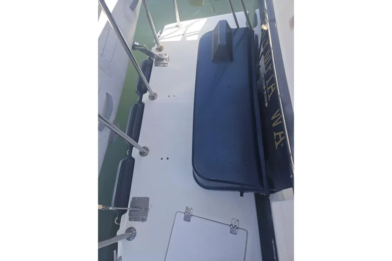 Slide: The Image of 2014 Ranger Tugs R-27 boat deck with railing and seating area. - 6