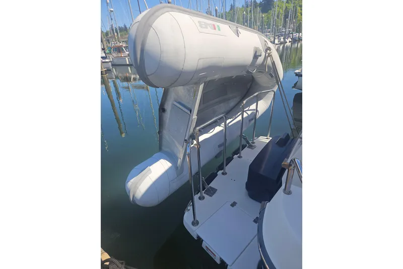 Slide: The Image of 2014 Ranger Tugs R-27 with inflatable dinghy on davit system at marina. - 7