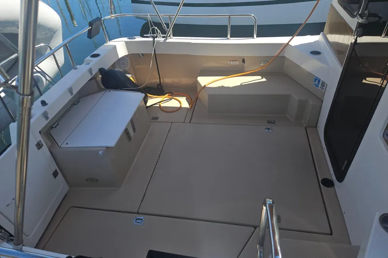 Slide: The Image of 2014 Ranger Tugs R-27 boat deck with storage compartments and railing. - 8