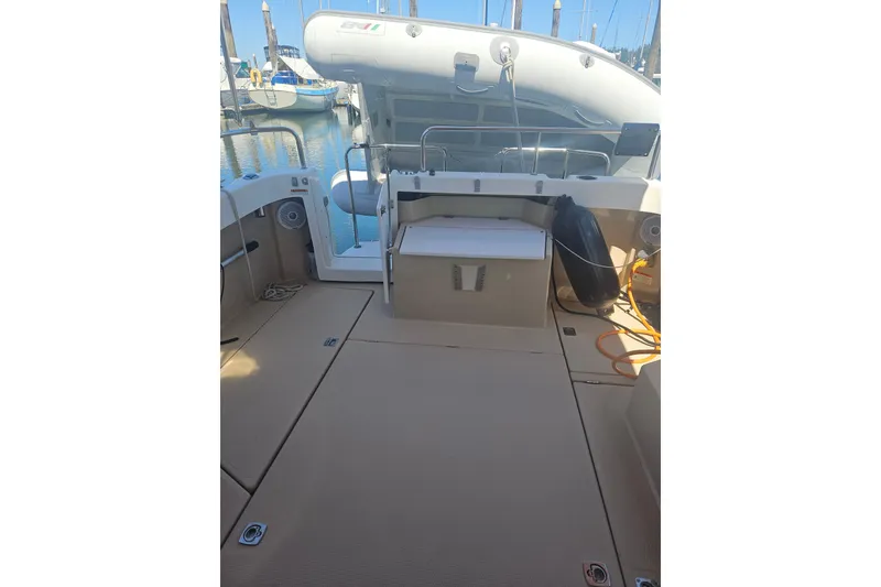 Slide: The Image of 2014 Ranger Tugs R-27 boat interior with seating and storage, docked at marina. - 9