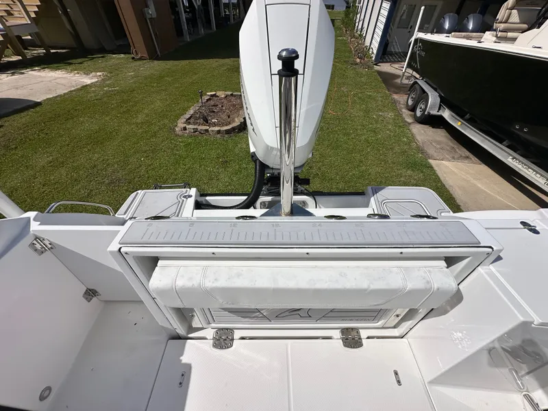 Slide: The Image of 2024 Blackfin 252 DC boat stern view with motor and seating. - 11