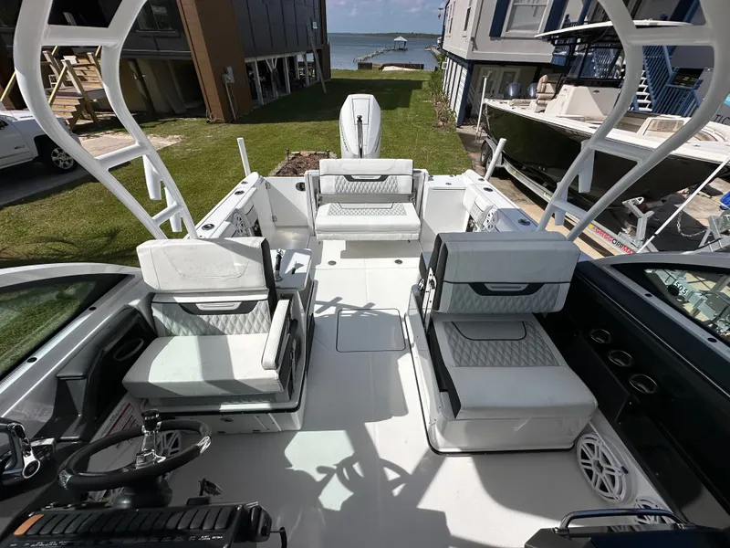 Slide: The Image of Interior view of 2024 Blackfin 252 DC boat by the water. - 13