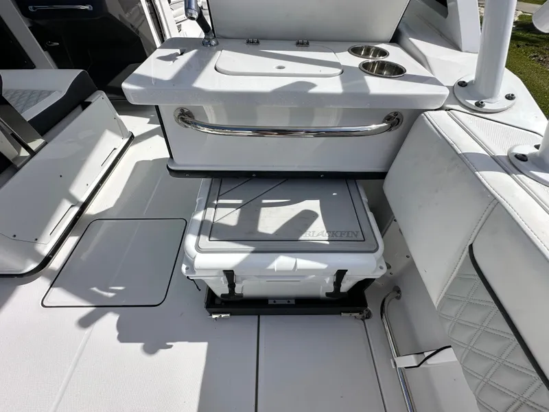 Slide: The Image of Interior of 2024 Blackfin 252 DC with cooler and seating area. - 19