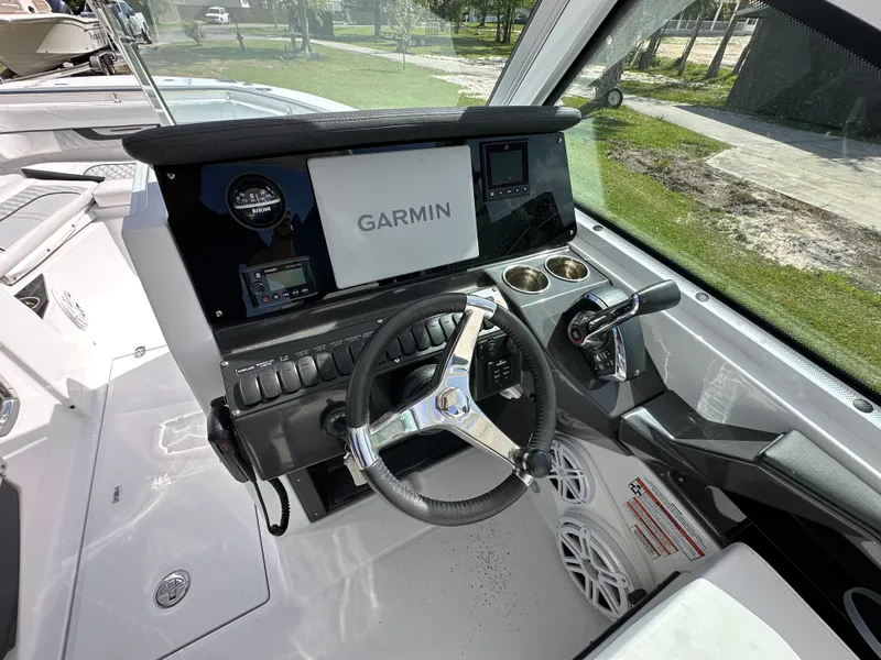 Slide: The Image of Interior view of 2024 Blackfin 252 DC boat cockpit with Garmin controls. - 26