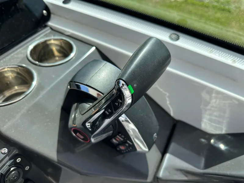 Slide: The Image of 2024 Blackfin 252 DC boat controls with cup holders. - 30
