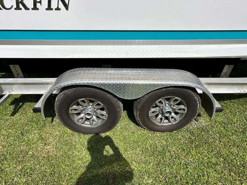 Slide: The Image of 2024 Blackfin 252 DC boat trailer on grass surface. - 5