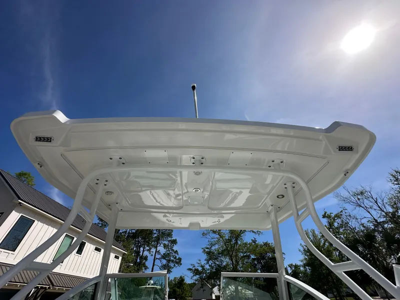 Slide: The Image of 2024 Blackfin 252 DC boat roof under blue sky. - 8