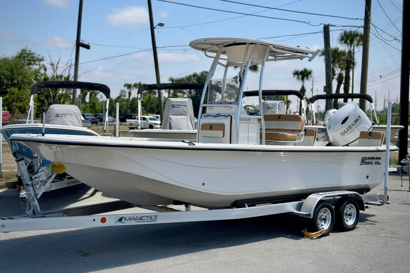 The Image of 2026 Carolina Skiff 23 LS boat on trailer, featuring Suzuki outboard motor. - 0