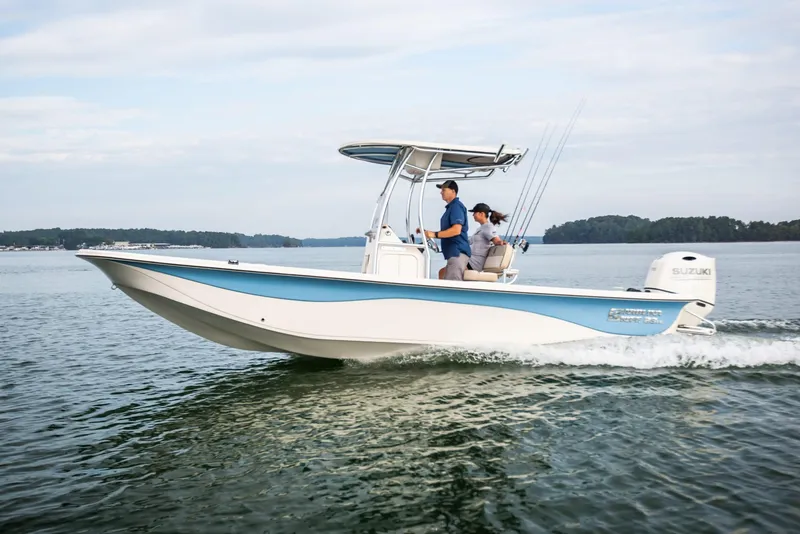 Slide: The Image of Manufacturer Provided Image: 2026 Carolina Skiff 23 LS boat cruising on a calm lake with two passengers. - 12