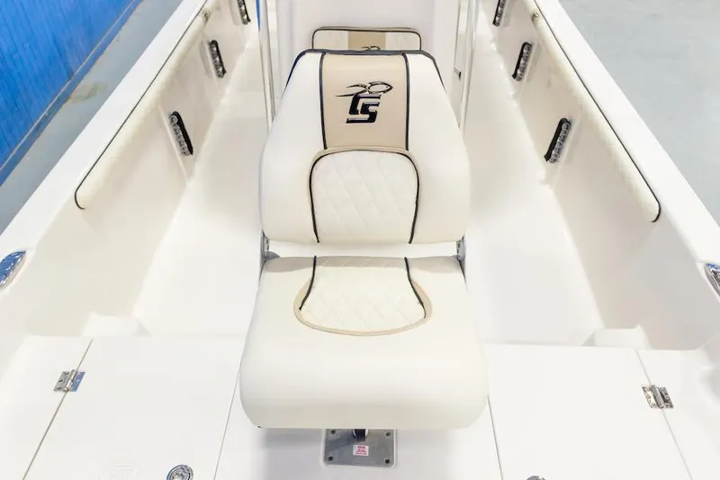 Slide: The Image of Manufacturer Provided Image: 2026 Carolina Skiff 23 LS boat interior with white cushioned seating and logo embroidery. - 13