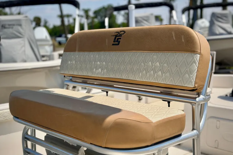 Slide: The Image of 2026 Carolina Skiff 23 LS boat seat with tan and white diamond pattern upholstery. - 4