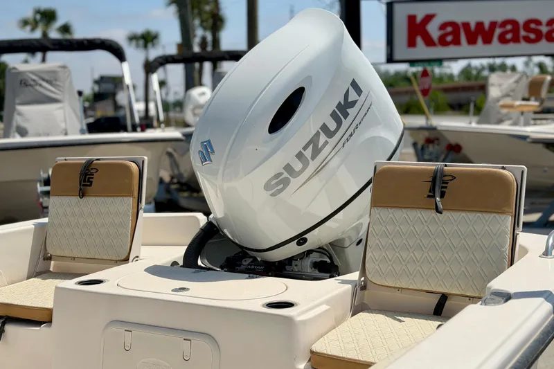 Slide: The Image of 2026 Carolina Skiff 23 LS boat with Suzuki outboard motor, featuring beige seating. - 5