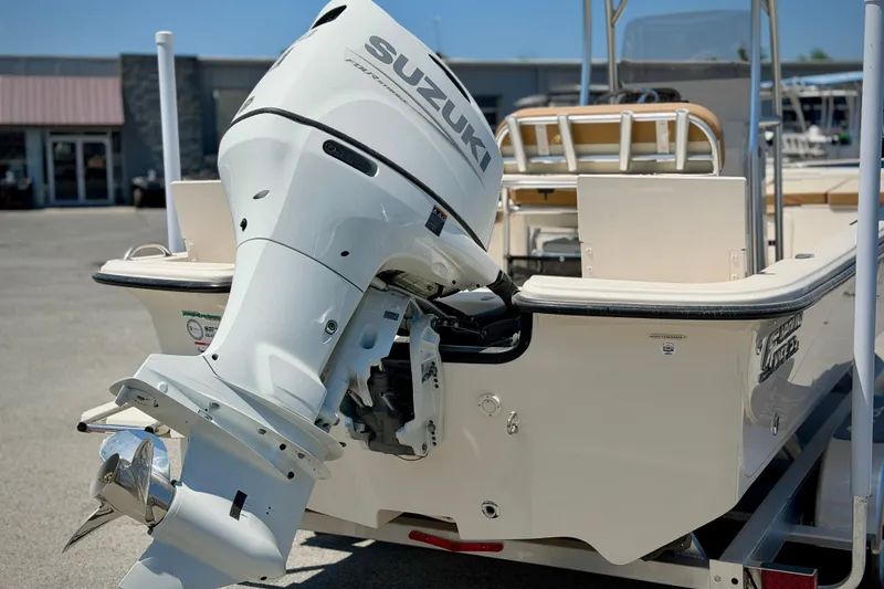 Slide: The Image of 2026 Carolina Skiff 23 LS boat with Suzuki outboard motor, parked on a trailer. - 7