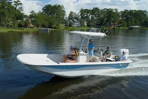 Slide: The Image of Manufacturer Provided Image: 2026 Carolina Skiff 23 LS boat cruising on a serene lake with passengers onboard. - 9