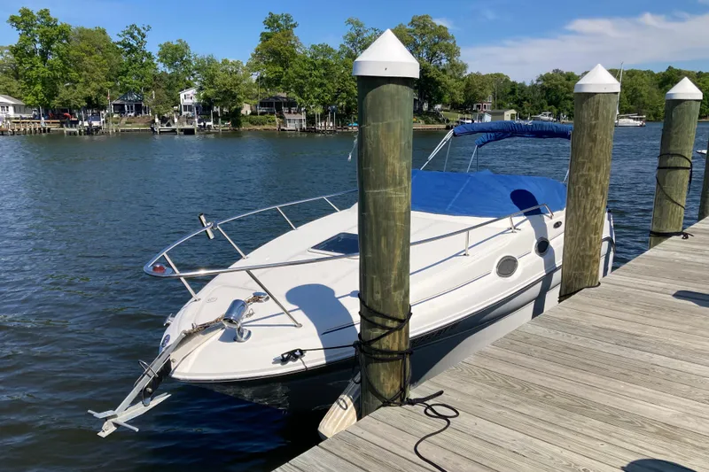 The Image of 2002 Sea Ray Sundancer 260 docked on a sunny day by a wooden pier. - 0