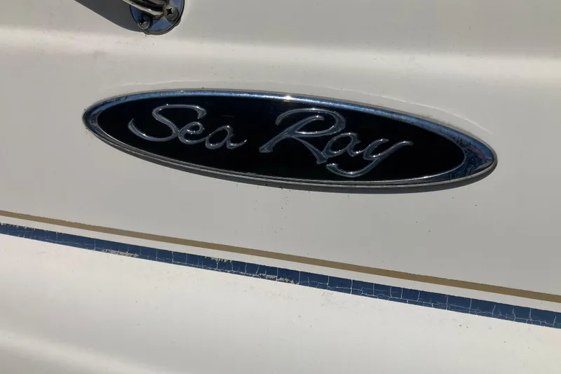Slide: The Image of Sea Ray Sundancer 260 2002 logo on boat exterior. - 11