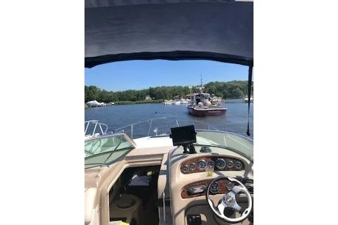 Slide: The Image of 2002 Sea Ray Sundancer 260 boat cockpit with scenic waterway view. - 13