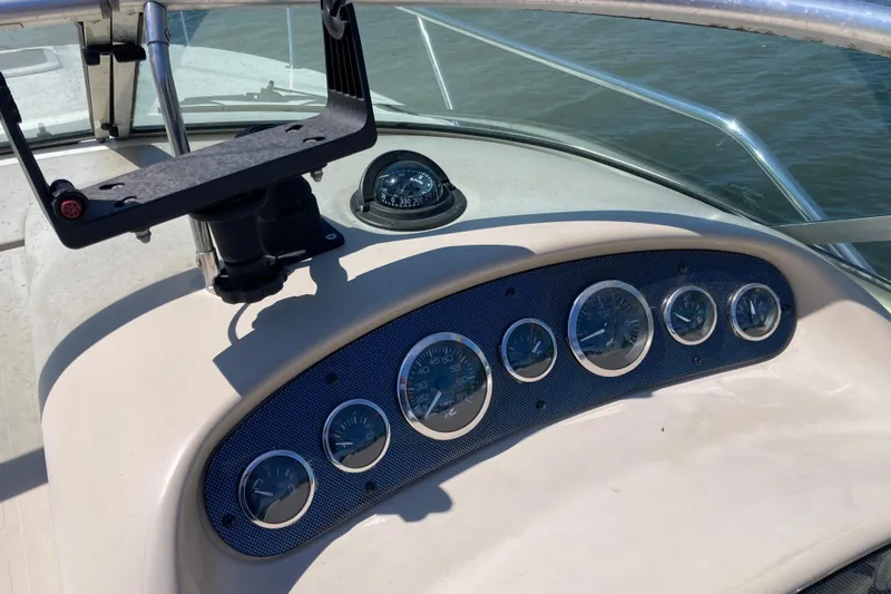 Slide: The Image of Dashboard of a 2002 Sea Ray Sundancer 260 boat with gauges and compass. - 16
