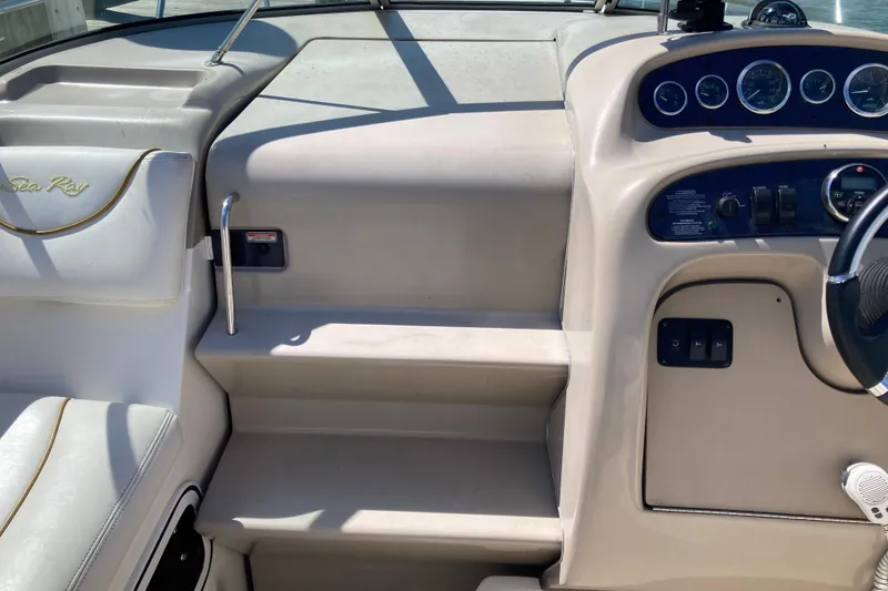 Slide: The Image of Interior view of 2002 Sea Ray Sundancer 260 boat cockpit with steering and controls. - 20