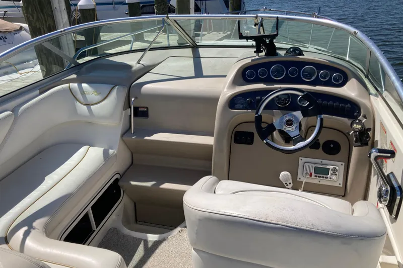 Slide: The Image of 2002 Sea Ray Sundancer 260 boat cockpit with steering wheel and control panel. - 22
