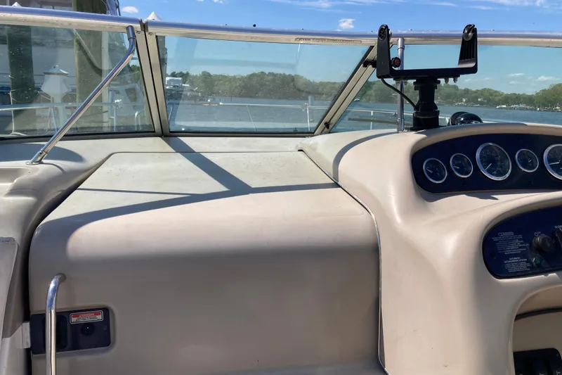 Slide: The Image of 2002 Sea Ray Sundancer 260 dashboard with gauges, windshield, and water view. - 23