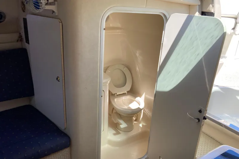 Slide: The Image of Interior of 2002 Sea Ray Sundancer 260 showing compact marine toilet area. - 35