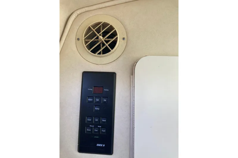 Slide: The Image of Control panel and vent inside a 2002 Sea Ray Sundancer 260 boat cabin. - 42
