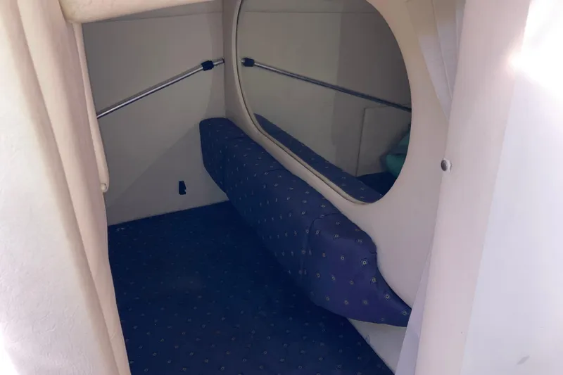 Slide: The Image of Interior cabin of 2002 Sea Ray Sundancer 260 with cushioned seating and mirror. - 45