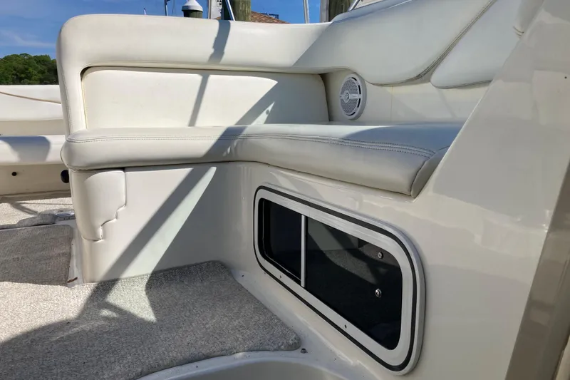 Slide: The Image of 2002 Sea Ray Sundancer 260 interior seating with storage compartment and speaker. - 46