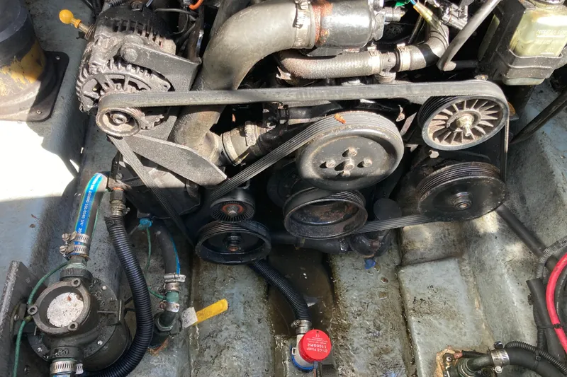 Slide: The Image of Engine compartment of a 2002 Sea Ray Sundancer 260 boat, showing belts and hoses. - 50