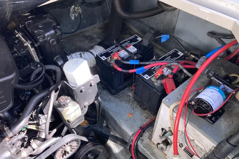 Slide: The Image of Engine compartment of a 2002 Sea Ray Sundancer 260 with batteries and wiring. - 52